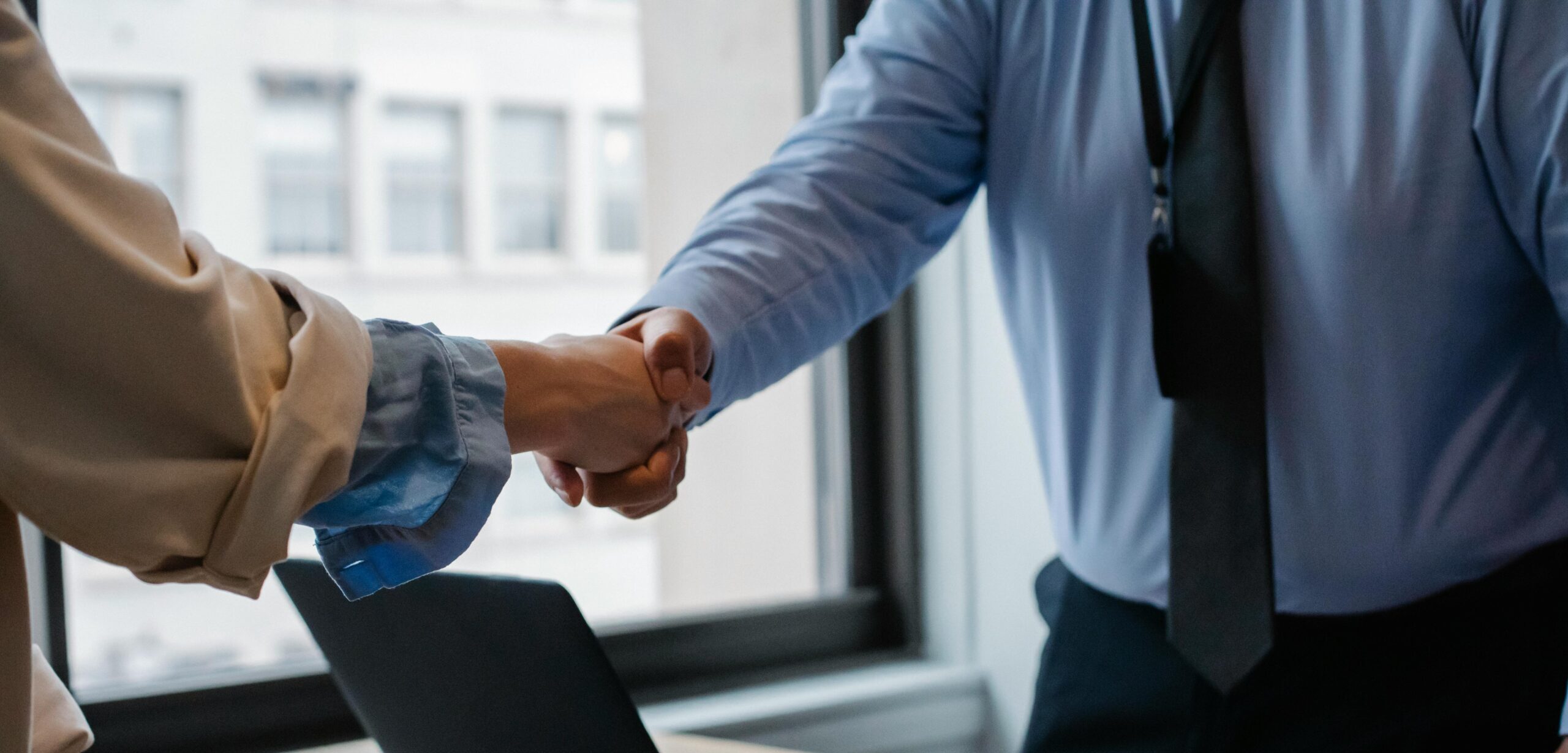 Two people shaking hands to symbolize reaching an agreement